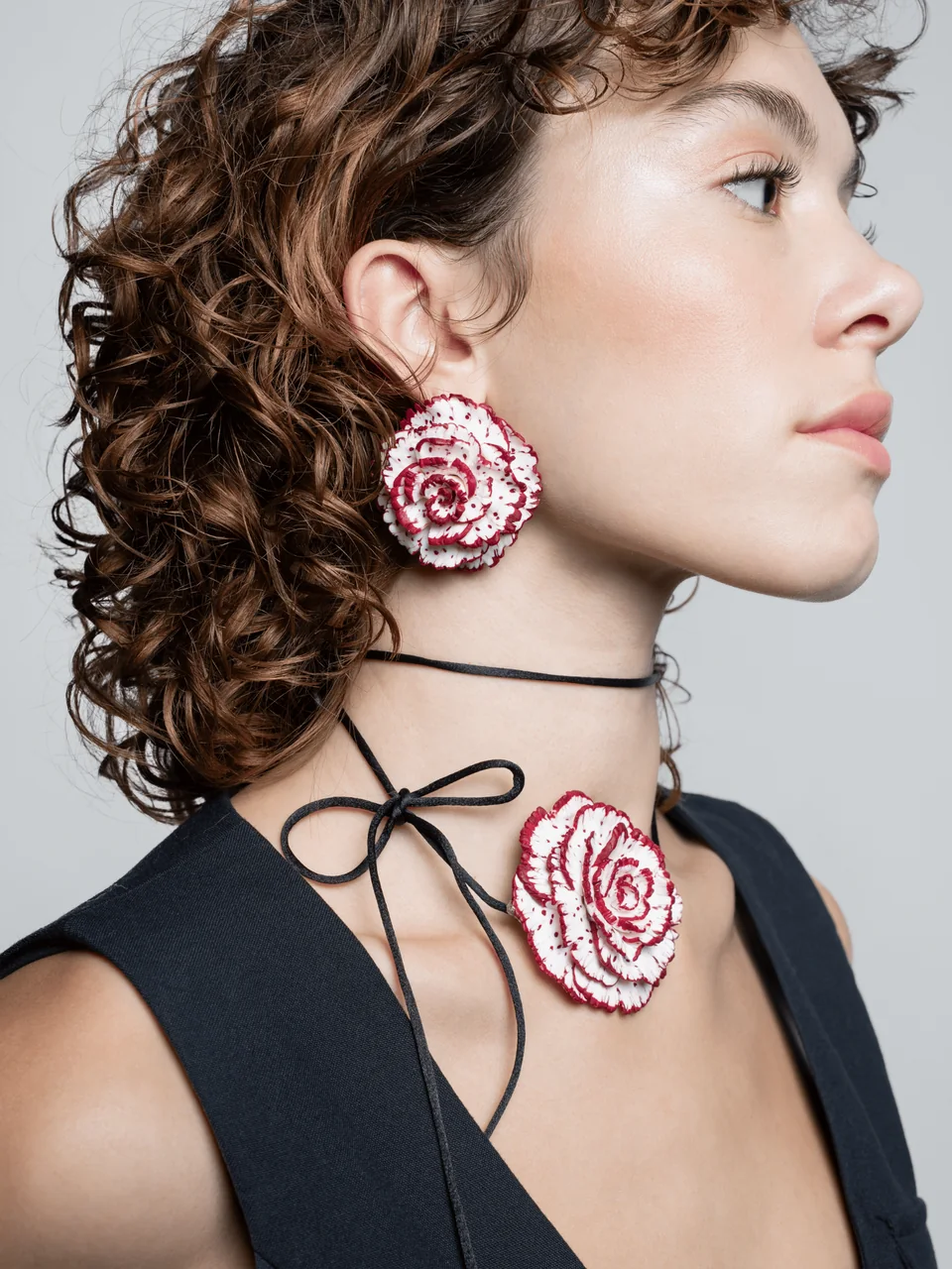 Pendientes de clavel y collar Berillús en blanco y burdeos, con un estilismo negro